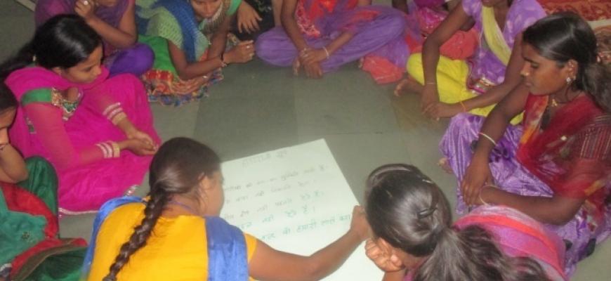 Photo of Indian adolescent girls in circle, during a lesson