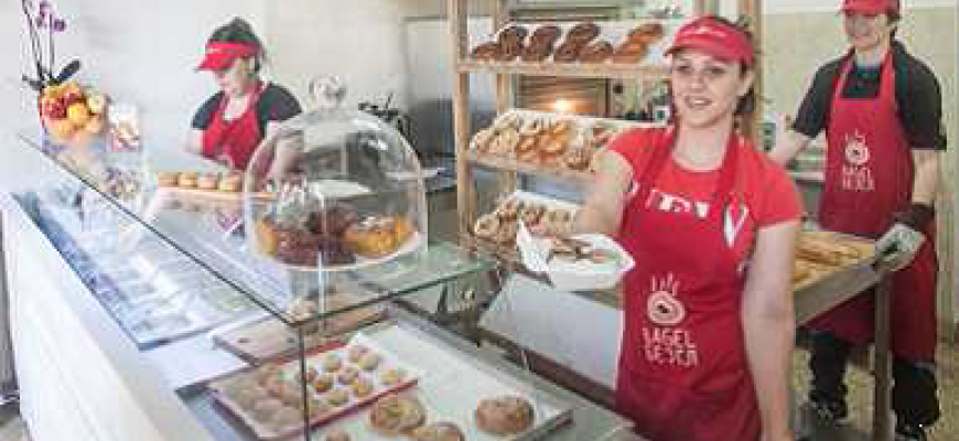 The image captures project’s beneficiaries managing ATINA bagel shop.